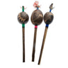 Three handcrafted shamanic rattles with carved wooden heads and colorful feather accents.