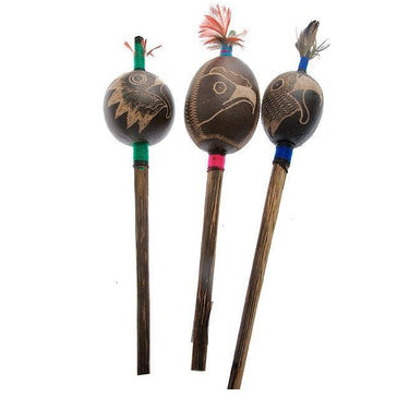 Three handcrafted shamanic rattles with carved wooden heads and colorful feather accents.