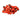 Small pile of vibrant red seeds with black spots on a white background.