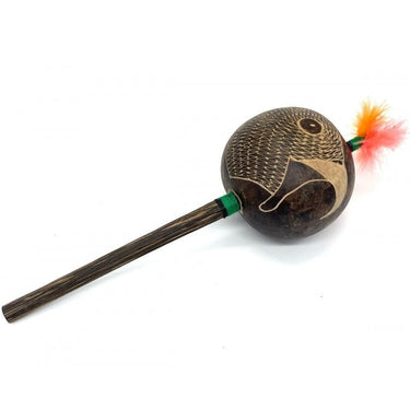 Hand-carved shamanic rattle with bird engraving and orange feathers on a wooden handle.