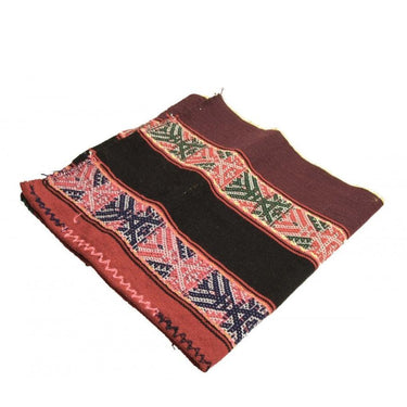Handwoven ethnic patterned fabric pouch with red and black tribal motifs.