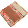 A folded woven textile, likely a blanket or throw, featuring a solid medium brown center panel, a light beige border, and a central decorative band with pink, beige, and black geometric and animal motifs.