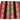 A traditional woven textile laid flat on a white background, featuring vertical stripes of solid burgundy, black, and ornate geometric bands in pink, green, and black.