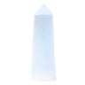 A natural white selenite crystal tower with a pointed tip, standing upright against a solid light blue background.