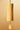 A hanging wooden bell chime with a cylindrical bamboo body and a teardrop-shaped wooden striker, suspended against a warm beige gradient background.
