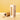 A bamboo wind instrument case standing upright next to its open cylindrical bamboo case, with a small wooden tag hanging from the open end. The white box has the brand name 'Koshi' printed vertically in black.