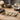 Tarot cards spread on a wooden table with a crystal ball, lit candle, and smudging sage.