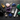 Assorted collection of polished tumbled stones, raw amethyst clusters, and clear quartz points on a dark slate surface.