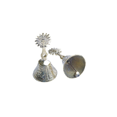 Ornate brass tingsha bells with sun motifs for sound healing and ritual practice