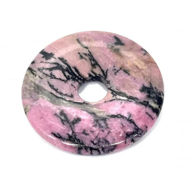 Pink rhodonite palm stone donut with black inclusions for meditation and energy work.