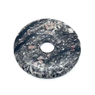 Polished dark grey and white speckled gemstone doughnut bead with a central hole