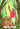 Illustrated tarot card 'I The Magician' showing a figure in a pink robe standing in a forest beside a tree stump with a sword, wand, cup, and planetary symbols, with the card title at the bottom.