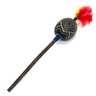 A handcrafted wooden toy mace or staff with a carved black oval head featuring geometric gold patterns, a long dark brown wooden handle, and a vibrant red and yellow feather tassel, shown on a plain white background.