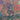 Illustrated card art titled 'SEVEN OF WANDS' showing a figure holding a long wand above a field of young plants, with swirling abstract lines and circular motifs in orange, blue, green, purple, and brown tones.