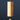 A minimalist wooden wind chime with a cylindrical body and a teardrop-shaped striker, hanging from a thin branch against a dark navy blue background.