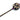 A handcrafted wooden mace or club with a round black head decorated with a beige sun face design and purple and pink feathers, set against a plain white background.